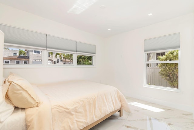 bedroom with marble finish floor and baseboards