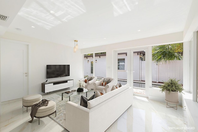 living room with marble finish floor, visible vents, and french doors