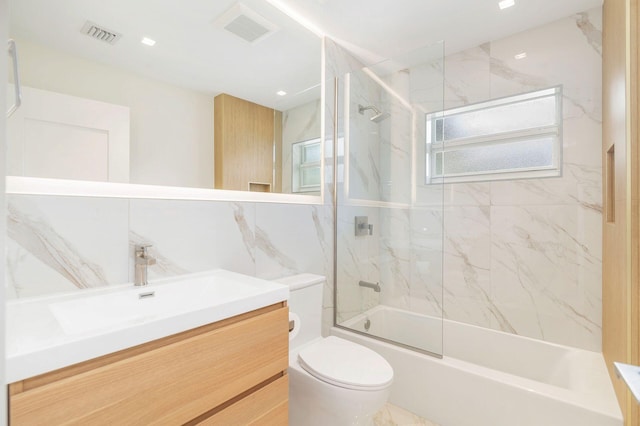 full bath featuring visible vents, toilet,  shower combination, marble finish floor, and vanity