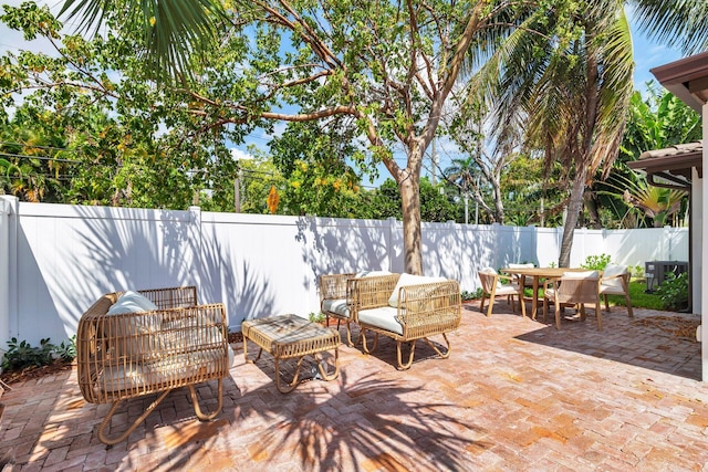 view of patio featuring a fenced backyard, outdoor lounge area, and outdoor dining area