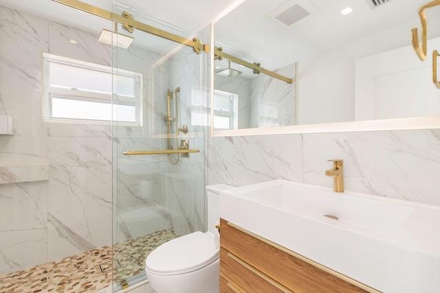 full bathroom featuring tile walls, a marble finish shower, visible vents, toilet, and vanity