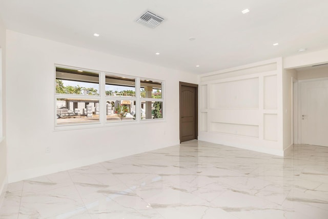 unfurnished room with recessed lighting, plenty of natural light, visible vents, and marble finish floor