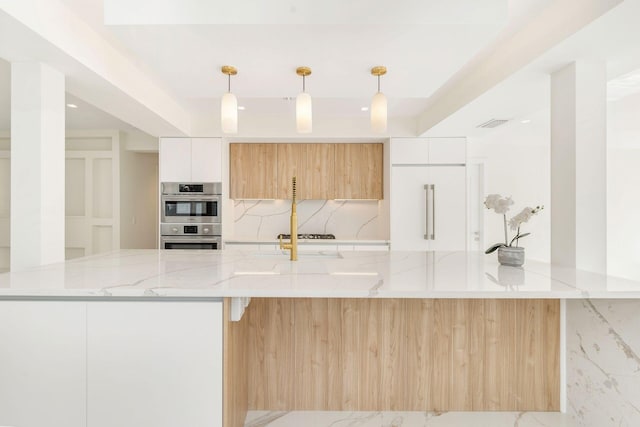 kitchen with tasteful backsplash, light stone counters, modern cabinets, and double oven