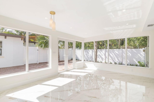 unfurnished sunroom featuring visible vents, baseboards, and marble finish floor