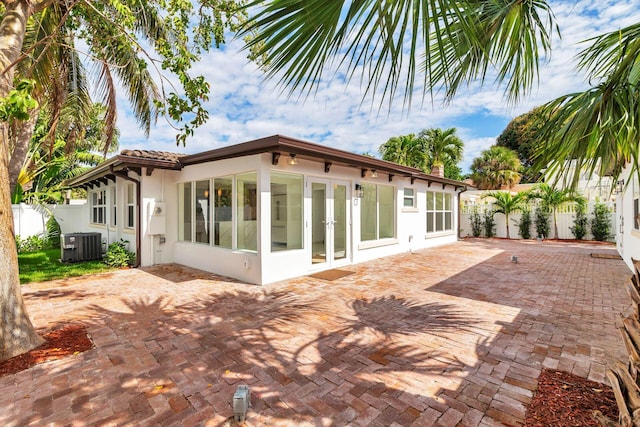 rear view of house featuring central AC, fence, french doors, stucco siding, and a patio area