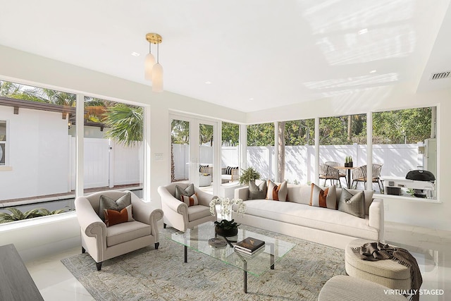 sunroom featuring french doors and visible vents