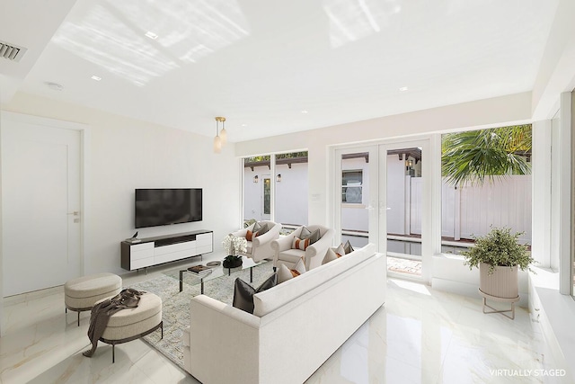 living room featuring french doors, marble finish floor, visible vents, and a healthy amount of sunlight