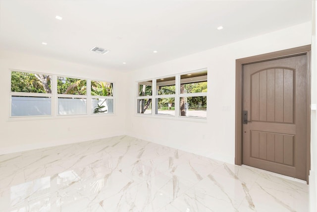 empty room featuring recessed lighting, marble finish floor, and visible vents