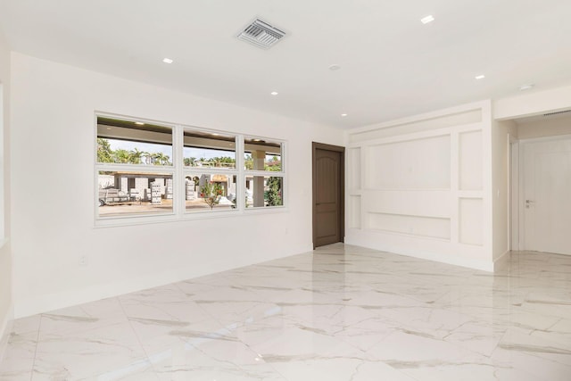 empty room featuring marble finish floor, recessed lighting, visible vents, and baseboards