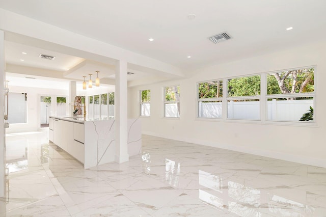 empty room with marble finish floor, baseboards, visible vents, and recessed lighting