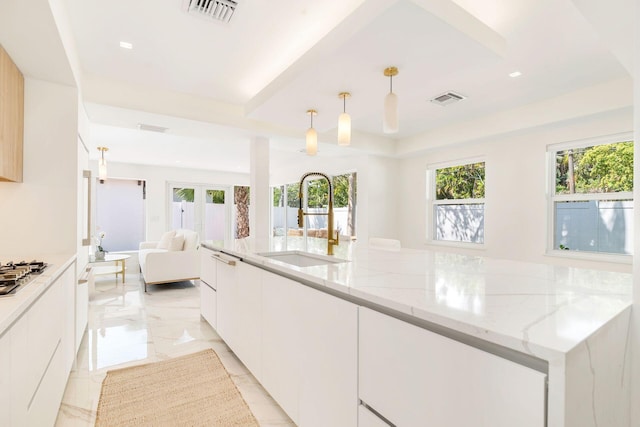 kitchen with a sink, visible vents, and a wealth of natural light