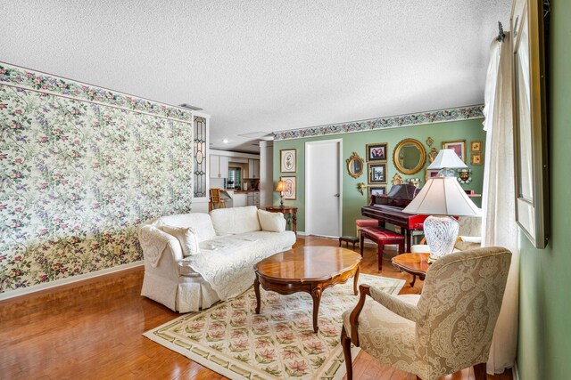 1210 Dolphin Rd, Singer Island, FL 33404 - living room with baseboards, wood finished floors, and a textured ceiling