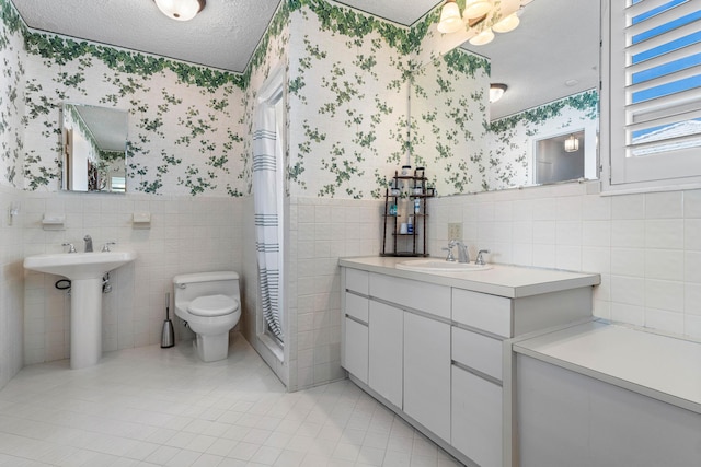 bathroom with tile patterned floors, a textured ceiling, and toilet