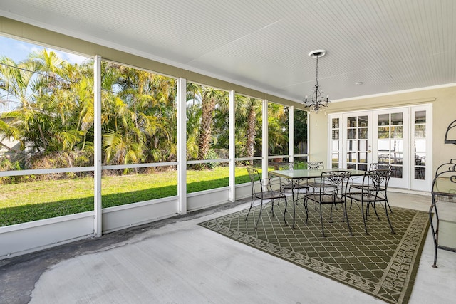 sunroom featuring a notable chandelier