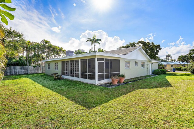 1210 Dolphin Rd, Singer Island, FL 33404 - view of yard featuring fence and a sunroom