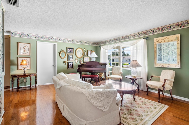 living room featuring hardwood / wood-style flooring and a textured ceiling