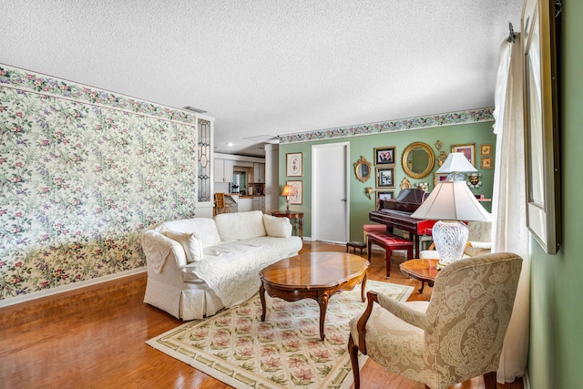 living room featuring hardwood / wood-style floors and a textured ceiling