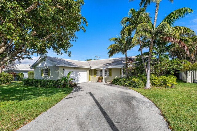 1210 Dolphin Rd, Singer Island, FL 33404 - doorway to property with aphalt driveway, brick siding, and a garage