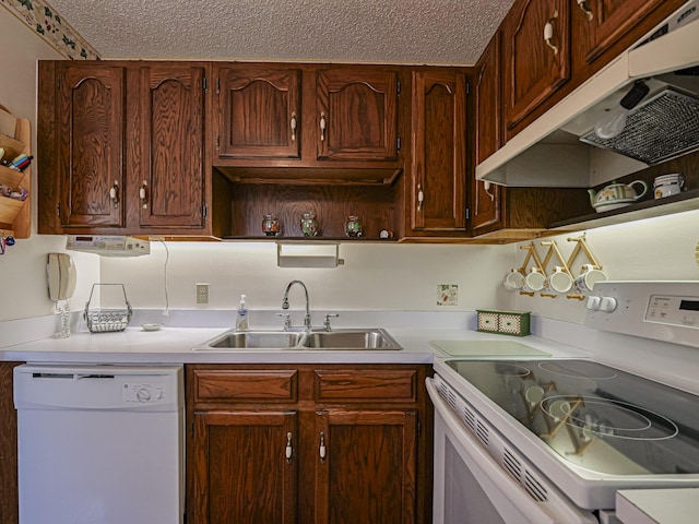 kitchen featuring sink, a textured ceiling, and white appliances