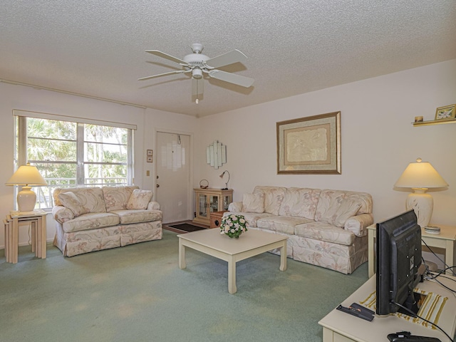 living room with ceiling fan, carpet, and a textured ceiling