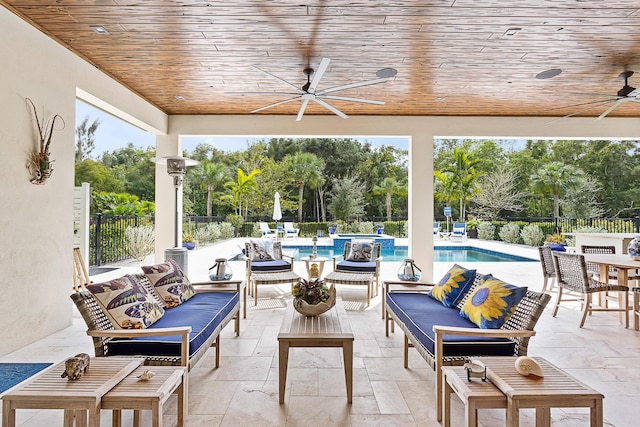 view of patio / terrace with a pool with connected hot tub, fence, an outdoor living space, and a ceiling fan