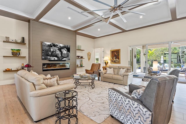 living area with light wood-type flooring, coffered ceiling, a fireplace, and beamed ceiling