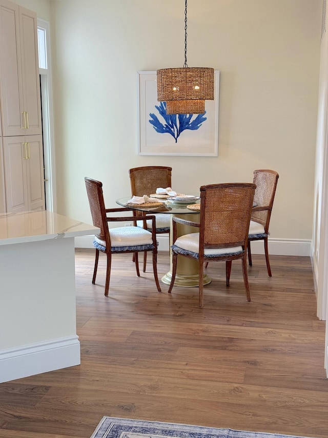 dining space with hardwood / wood-style floors