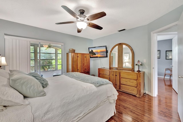 bedroom with wood-type flooring and ceiling fan