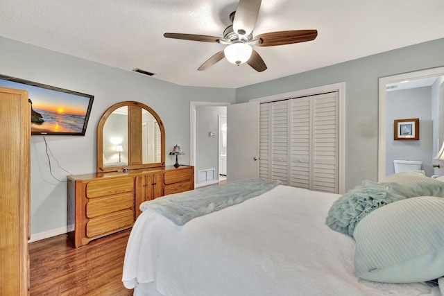 bedroom featuring wood-type flooring, ceiling fan, and a closet