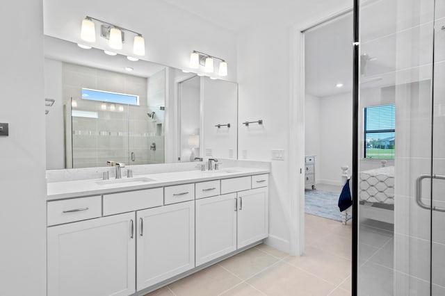 bathroom featuring tile patterned flooring, vanity, and walk in shower