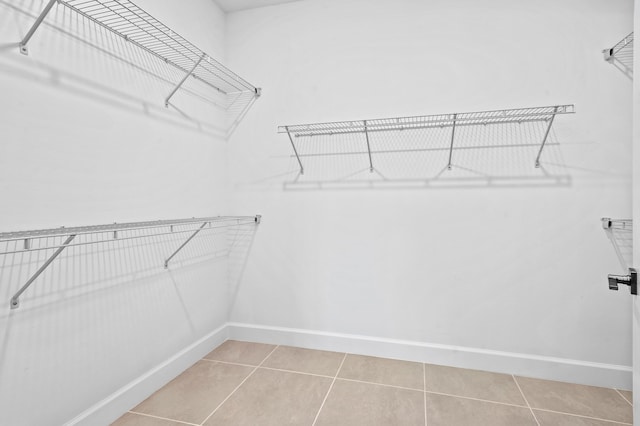 spacious closet featuring tile patterned flooring