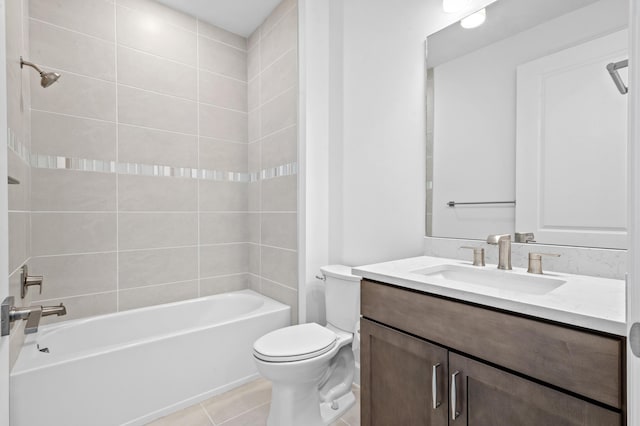 full bathroom featuring vanity, tile patterned flooring, tiled shower / bath combo, and toilet