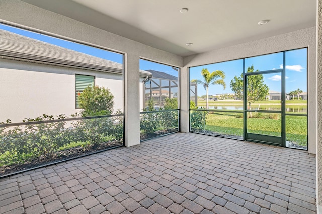 unfurnished sunroom with a water view