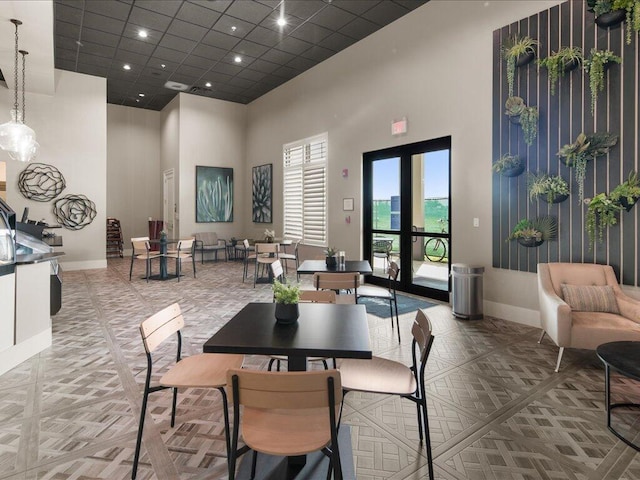 dining area featuring a high ceiling