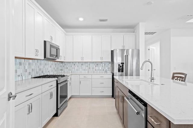 kitchen featuring stainless steel appliances and white cabinetry