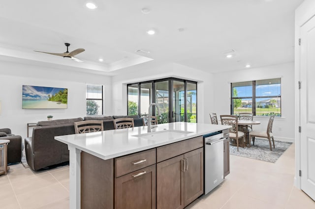 kitchen with a kitchen island with sink, sink, a healthy amount of sunlight, and dishwasher