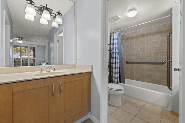 full bathroom with ceiling fan, tile patterned flooring, shower / tub combo, vanity, and toilet