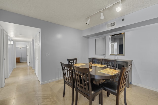 dining area with a textured ceiling