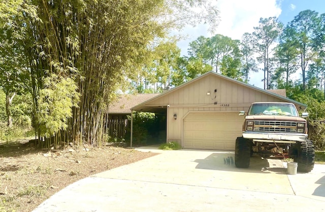 view of front of property featuring a garage, driveway, and a shingled roof