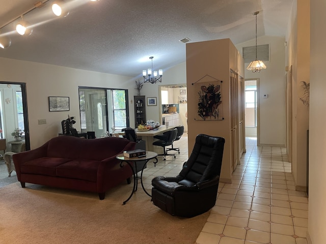 living area with lofted ceiling, visible vents, an inviting chandelier, light tile patterned flooring, and a textured ceiling