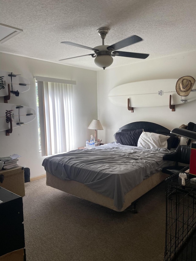 carpeted bedroom with a textured ceiling and a ceiling fan