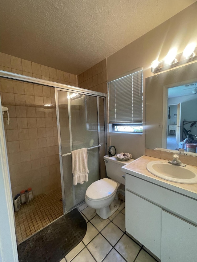 full bathroom with toilet, tile patterned flooring, a textured ceiling, vanity, and a shower stall