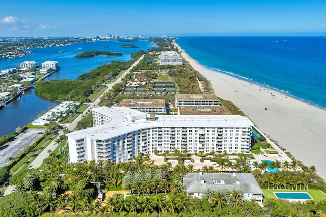 birds eye view of property with a water view and a beach view