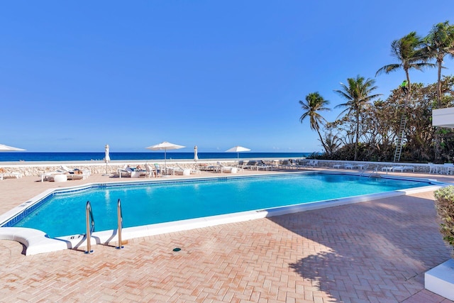 view of swimming pool featuring a water view