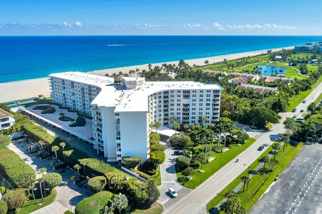 drone / aerial view featuring a view of the beach and a water view