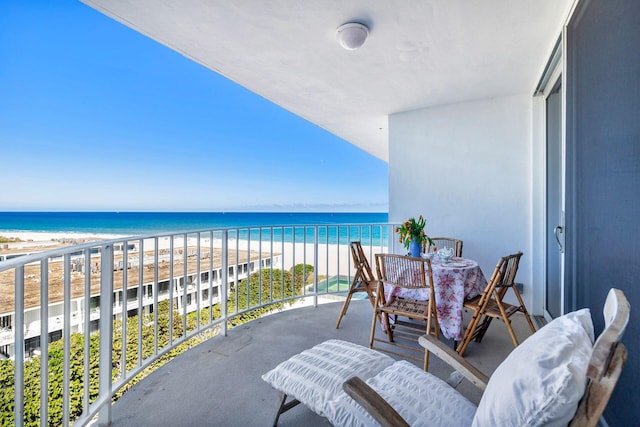 balcony with a water view and a beach view