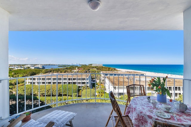 balcony with a water view and a beach view