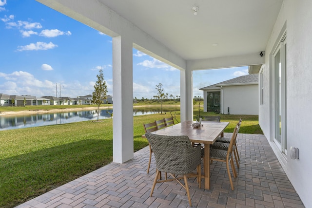 view of patio / terrace with a water view and outdoor dining area