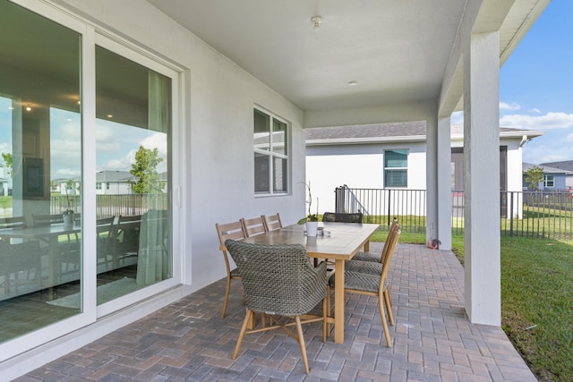 view of patio with fence and outdoor dining area