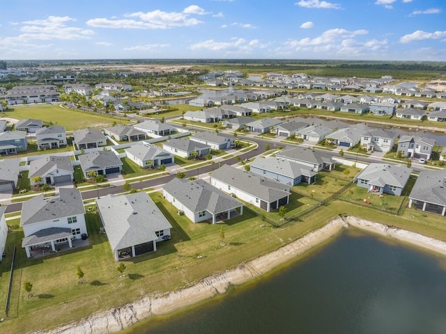 bird's eye view featuring a water view and a residential view